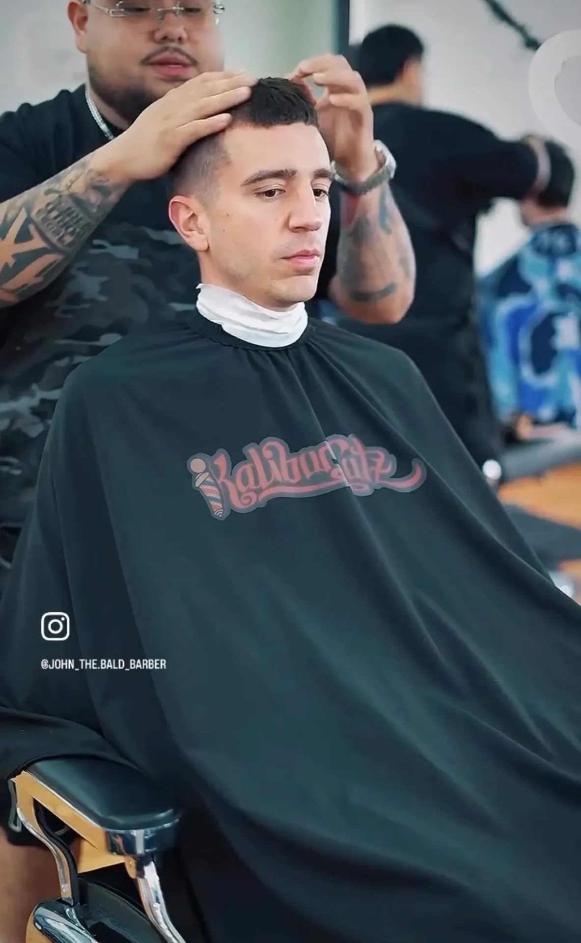 Man getting haircut at barbershop.