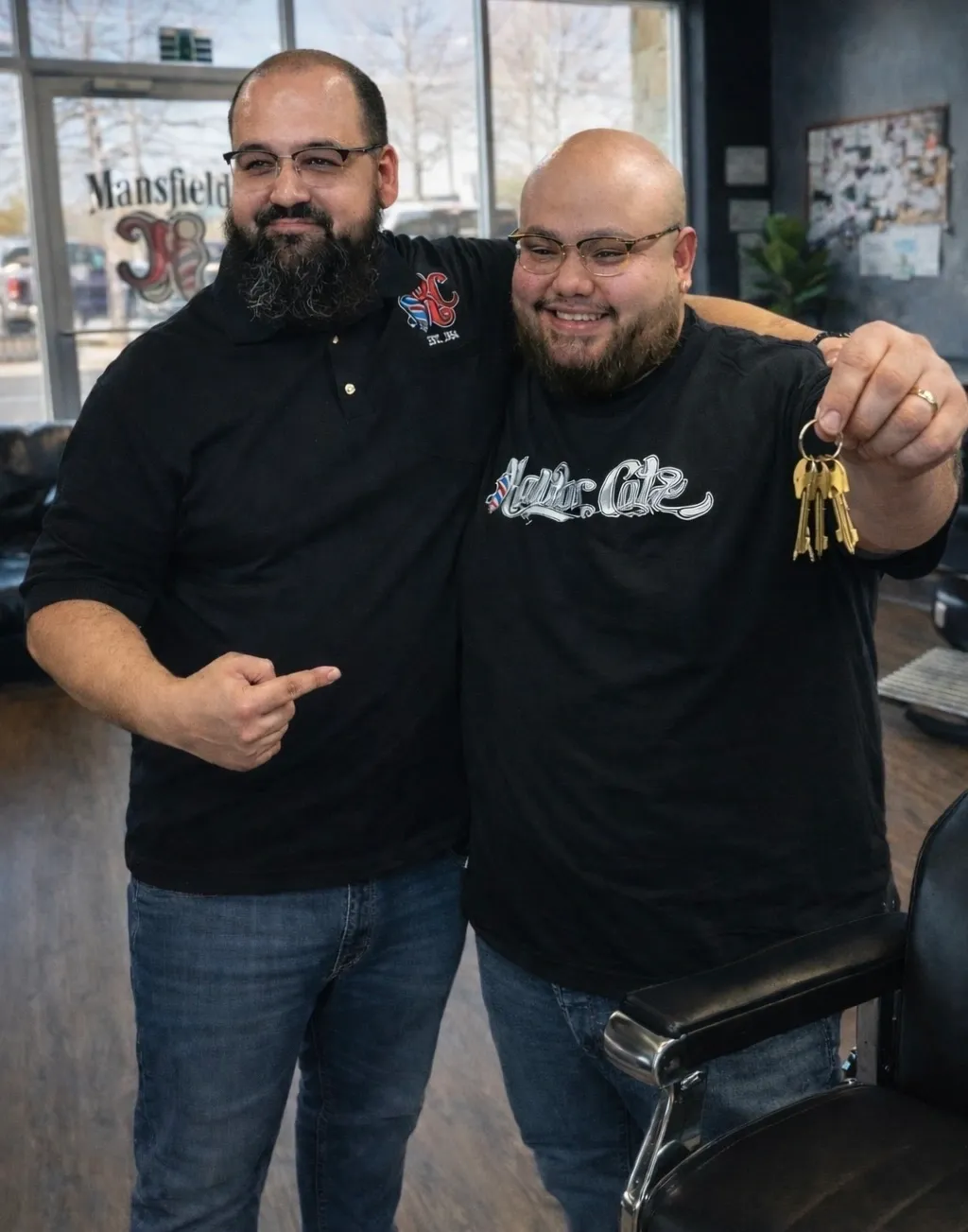 Two men celebrating with a key.